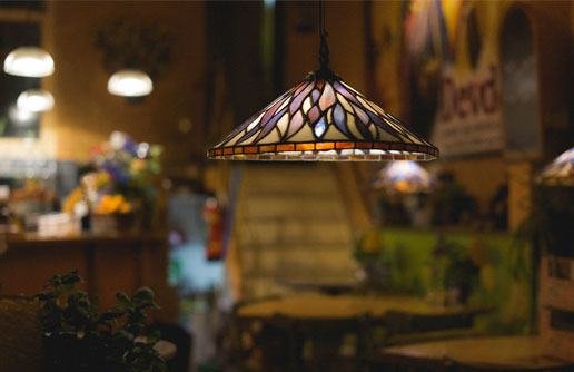 A warmly lit café with hanging lamps