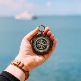 A compass held in an outstretched hand